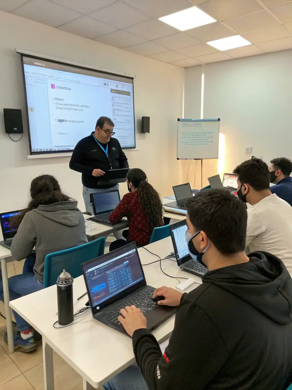 An S4B Tech trainer leading a workshop on the latest cybersecurity protocols, with participants actively engaged in hands-on exercises.